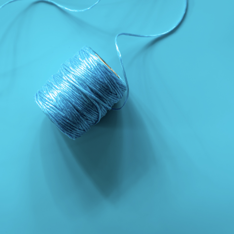 blue-cotton-coil-on-blue-clean-background